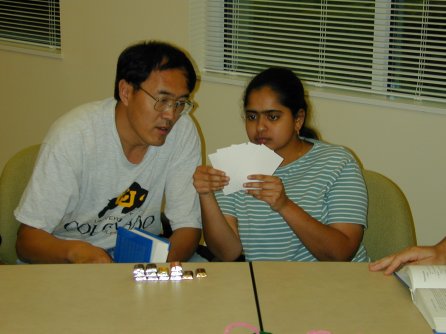 two people looking at their hand of cards