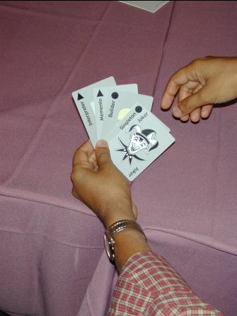 a hand of four cards with a joker on top