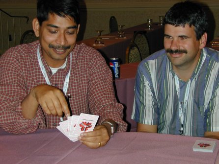 two people looking at a hand of cards