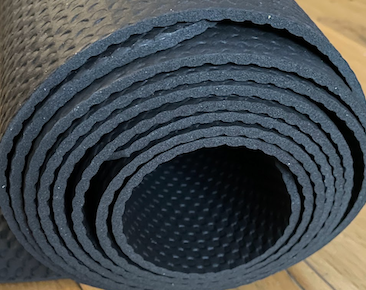 photo of a tigthly rolled-up exercise mat